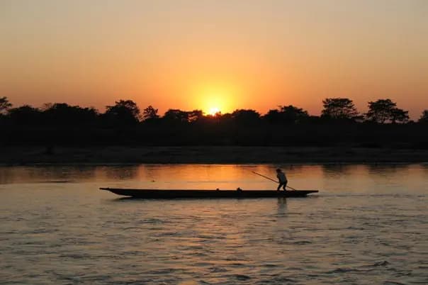 Dugout canoe on the Rapti river at sunset